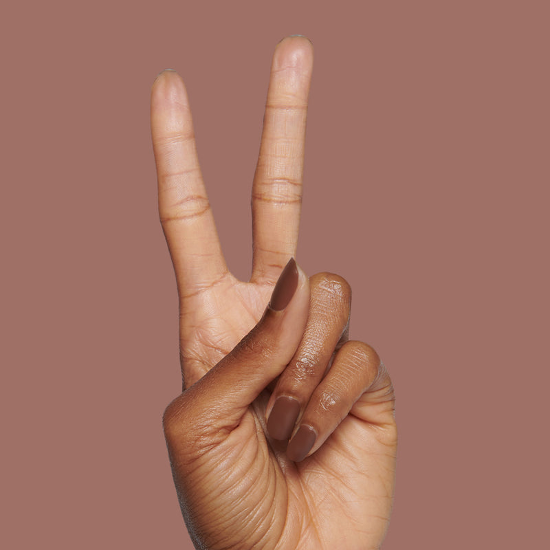 Hand with matte brown nails in a peace sign gesture featuring The Matte Top Coat for a smooth, durable manicure finish