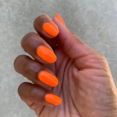 Orange Wedge polish on customer hand