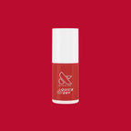 Smooch quick dry nail polish bottle in rich scarlet red on matching red background for at-home mani