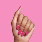 Hand with glossy WILD ORCHID polish manicure in rich magenta purple against solid pink background