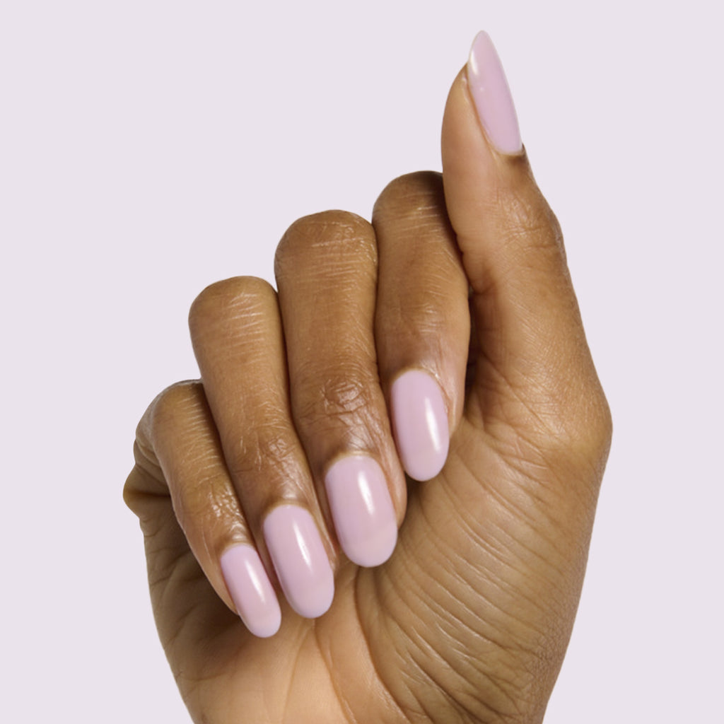 Hand with medium-length nails painted soft milky lavender in Lavender Stems gel polish by Olive and June