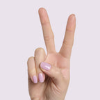 Hand showing medium-length nails with glossy Lavender Stems milky sheer gel polish manicure by Olive and June