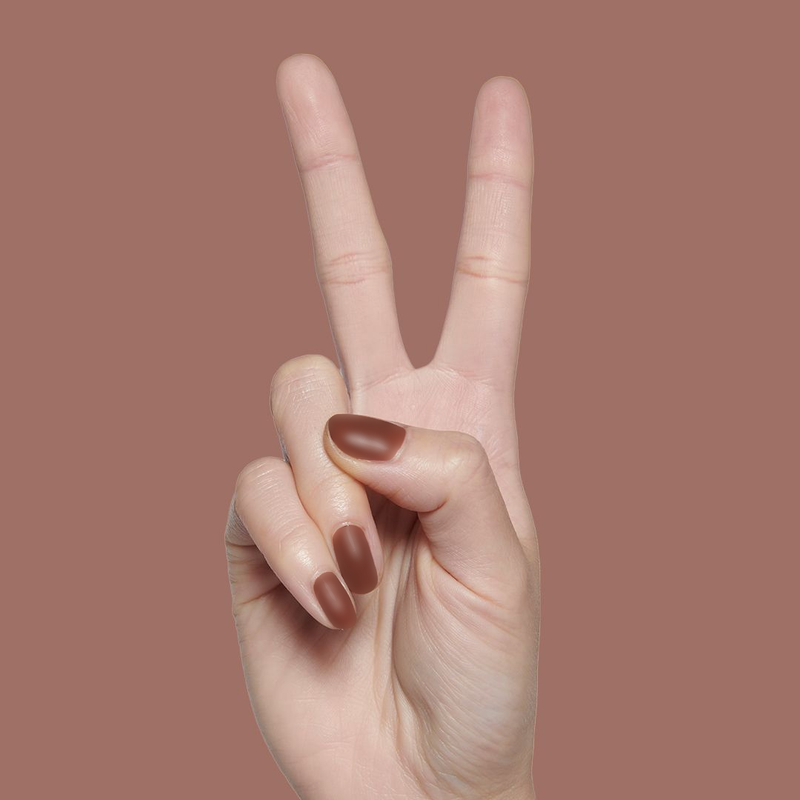Hand with matte brown nails in a peace sign gesture coated in The Matte Top Coat for a smooth manicure finish