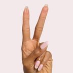 Hand showing two fingers with milky pink iridescent Pink Capiz nail polish for a delicate manicure look