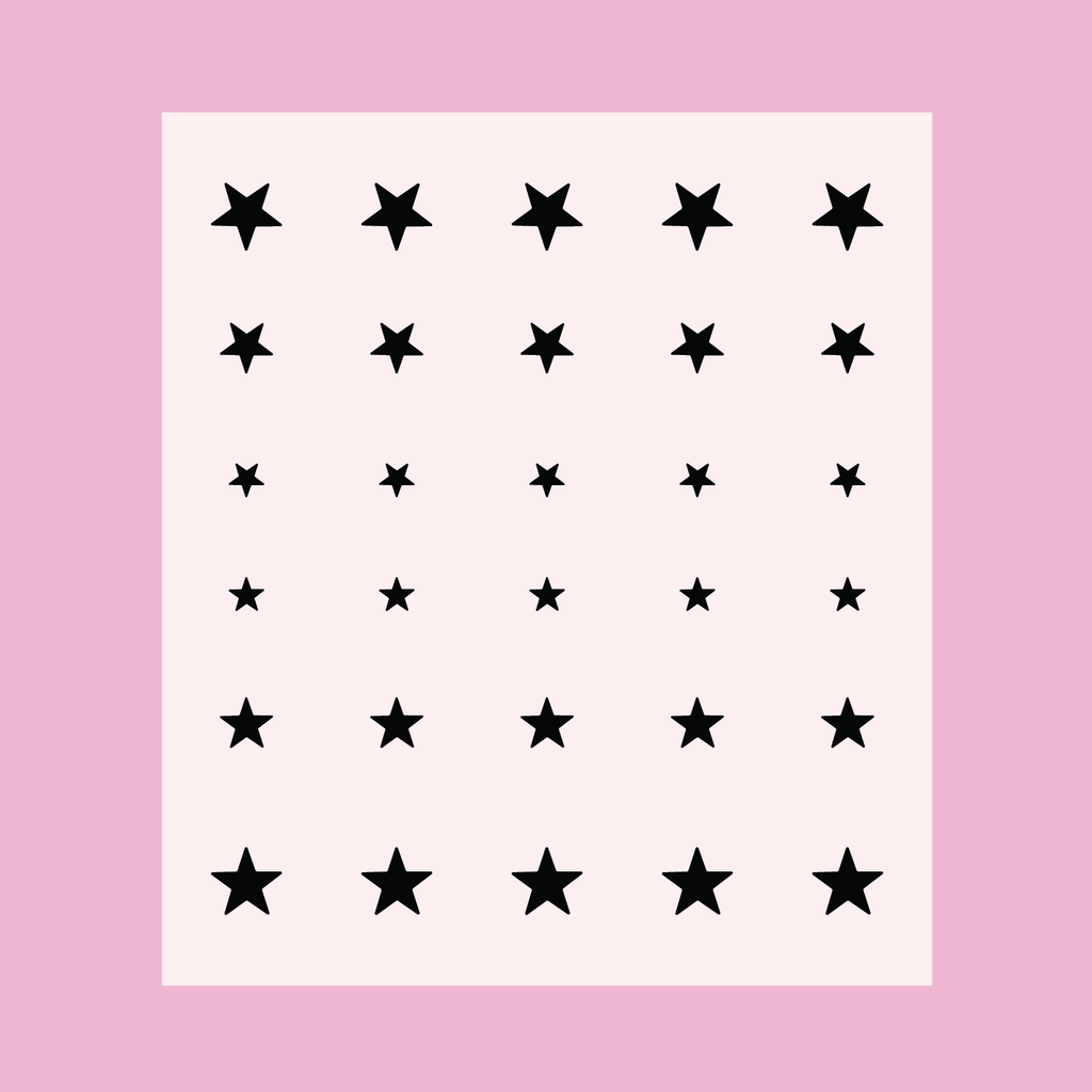 Sheet of black star stickers in varying sizes for Stars nail art and manicure decoration on a pale pink background